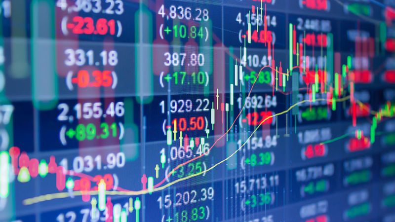 Stock market chart with fluctuating numbers and graphs on a digital screen indicating financial trading dynamics.